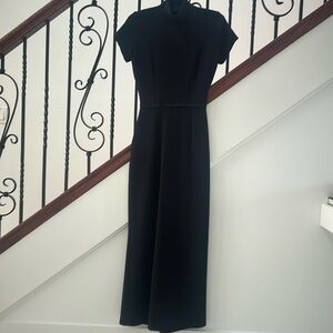 Full length, body skimming, high neck, short sleeve gown, rear zip. Formal